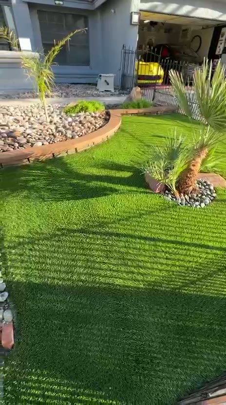 Walkthrough of a front yard artificial turf install with palms and river rock